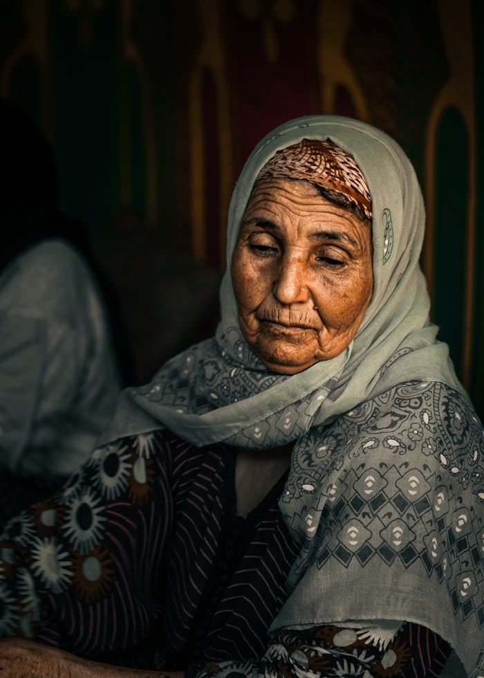 Striking portrait of an elderly woman in traditional Moroccan clothing, captured in Imlil.